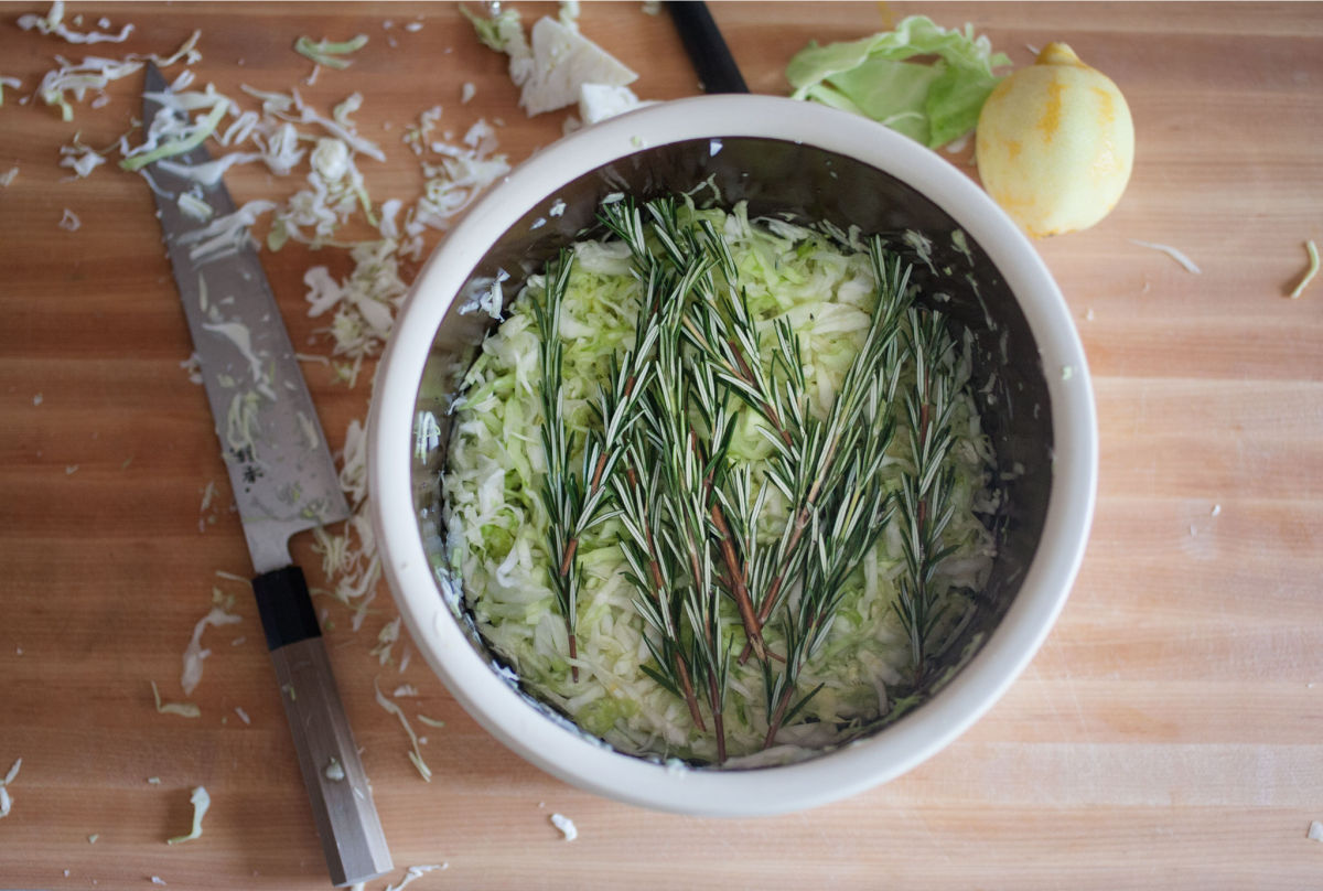 Mixing rosemary into sauerkraut